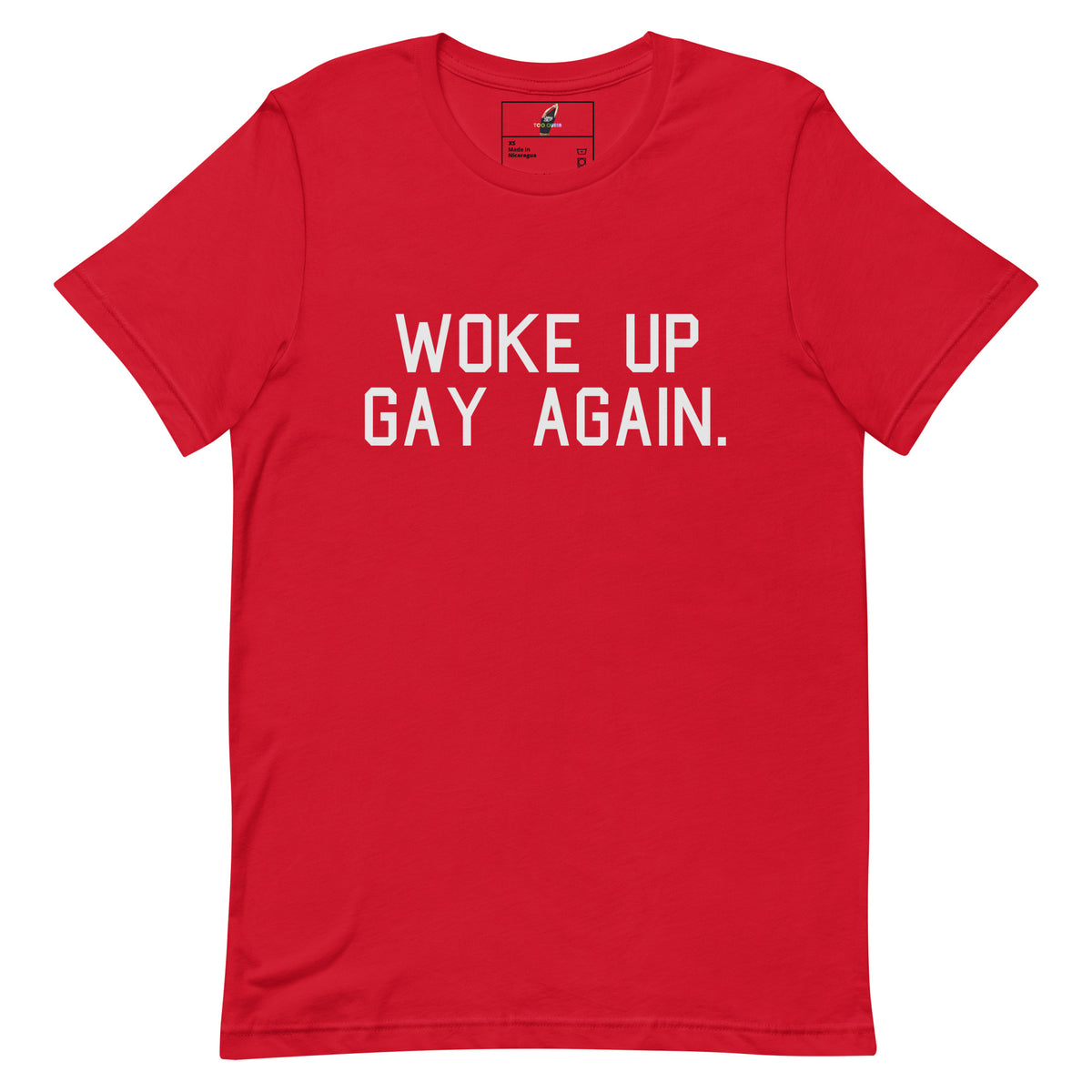 A red short-sleeve crewneck t-shirt with the slogan 'WOKE UP GAY AGAIN.' printed in white block letters across the chest, displayed on a solid white background.
