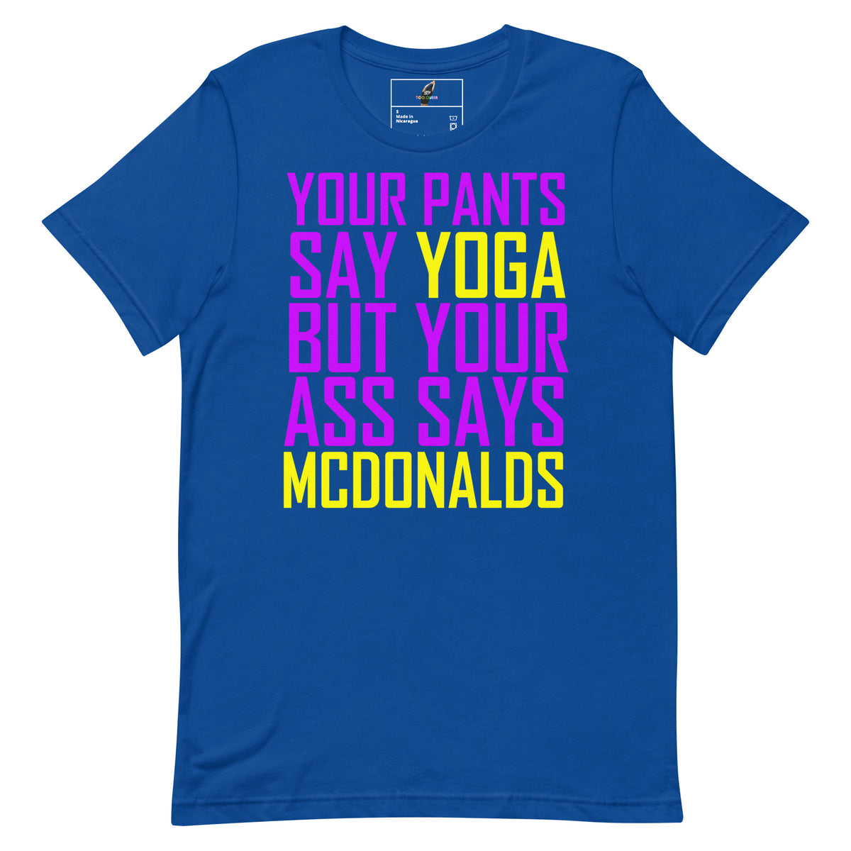 A royal blue short-sleeve t-shirt with a bold graphic text print on the front. The text reads 'YOUR PANTS SAY YOGA BUT YOUR ASS SAYS MCDONALDS' in alternating bright magenta and yellow fonts, displayed on a clean white background.