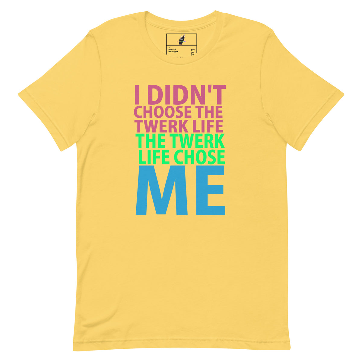 A yellow short-sleeve t-shirt with a colorful graphic text print on the front reading 'I DIDN'T CHOOSE THE TWERK LIFE THE TWERK LIFE CHOSE ME' in pink, green, and blue.