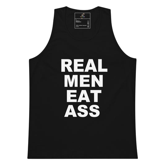 A black sleeveless tank top with the phrase 'REAL MEN EAT ASS' printed in bold white capital letters on the front, shown against a plain white background.