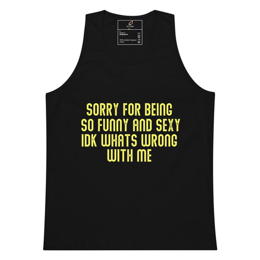 A black sleeveless tank top with bold yellow text on the front reading 'SORRY FOR BEING SO FUNNY AND SEXY IDK WHATS WRONG WITH ME'. The tank top is shown flat against a plain white background, with a small interior neck label visible at the top.