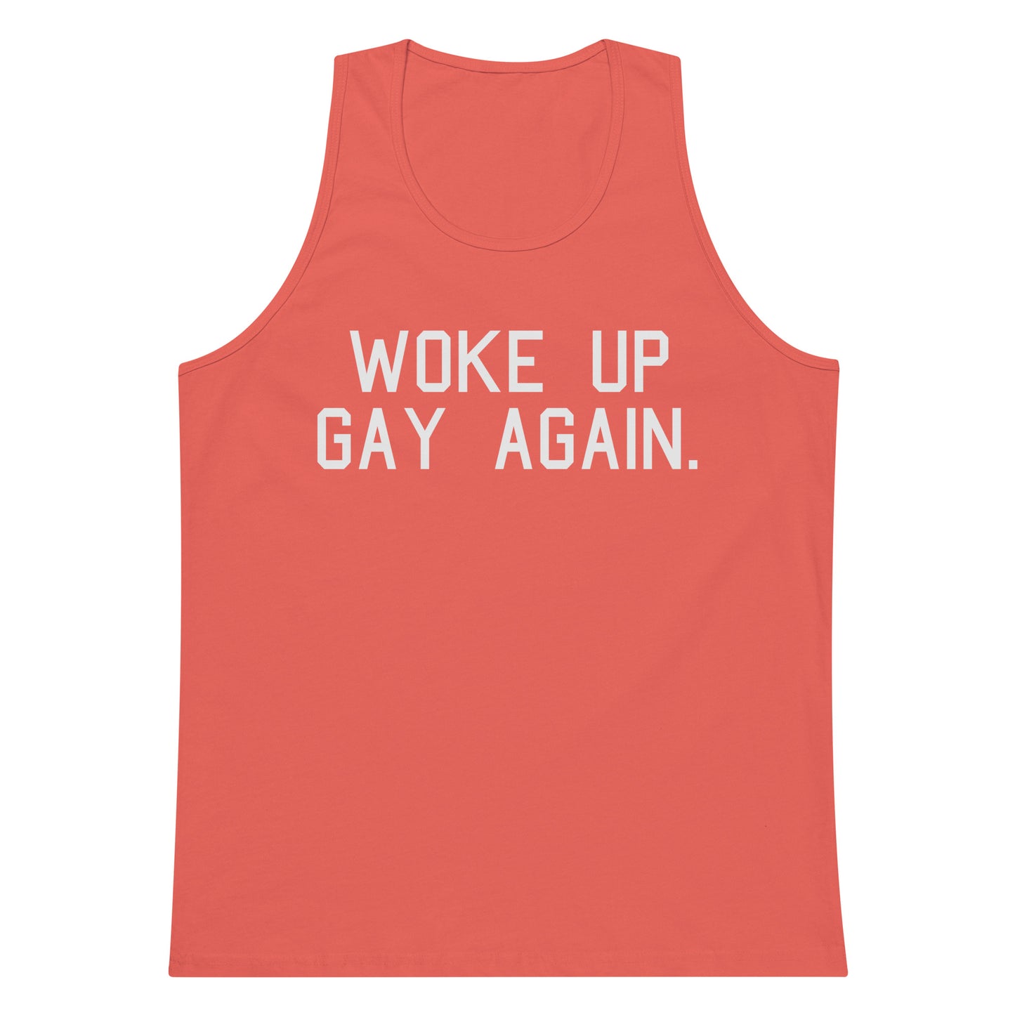 A coral pink tank top with the phrase 'WOKE UP GAY AGAIN.' printed in bold white capital letters across the chest, shown against a plain white background.
