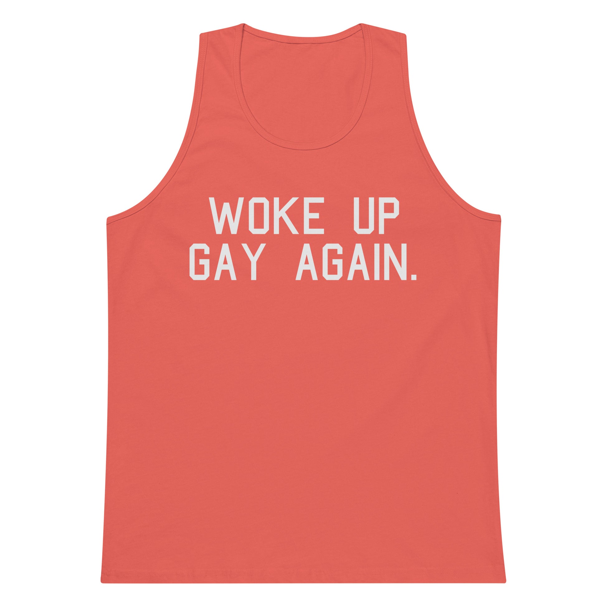 A coral pink tank top with the phrase 'WOKE UP GAY AGAIN.' printed in bold white capital letters across the chest, shown against a plain white background.