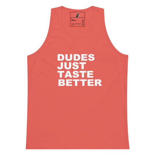 A coral pink sleeveless tank top with bold white text reading 'DUDES JUST TASTE BETTER' printed on the front, shown against a plain white background.
