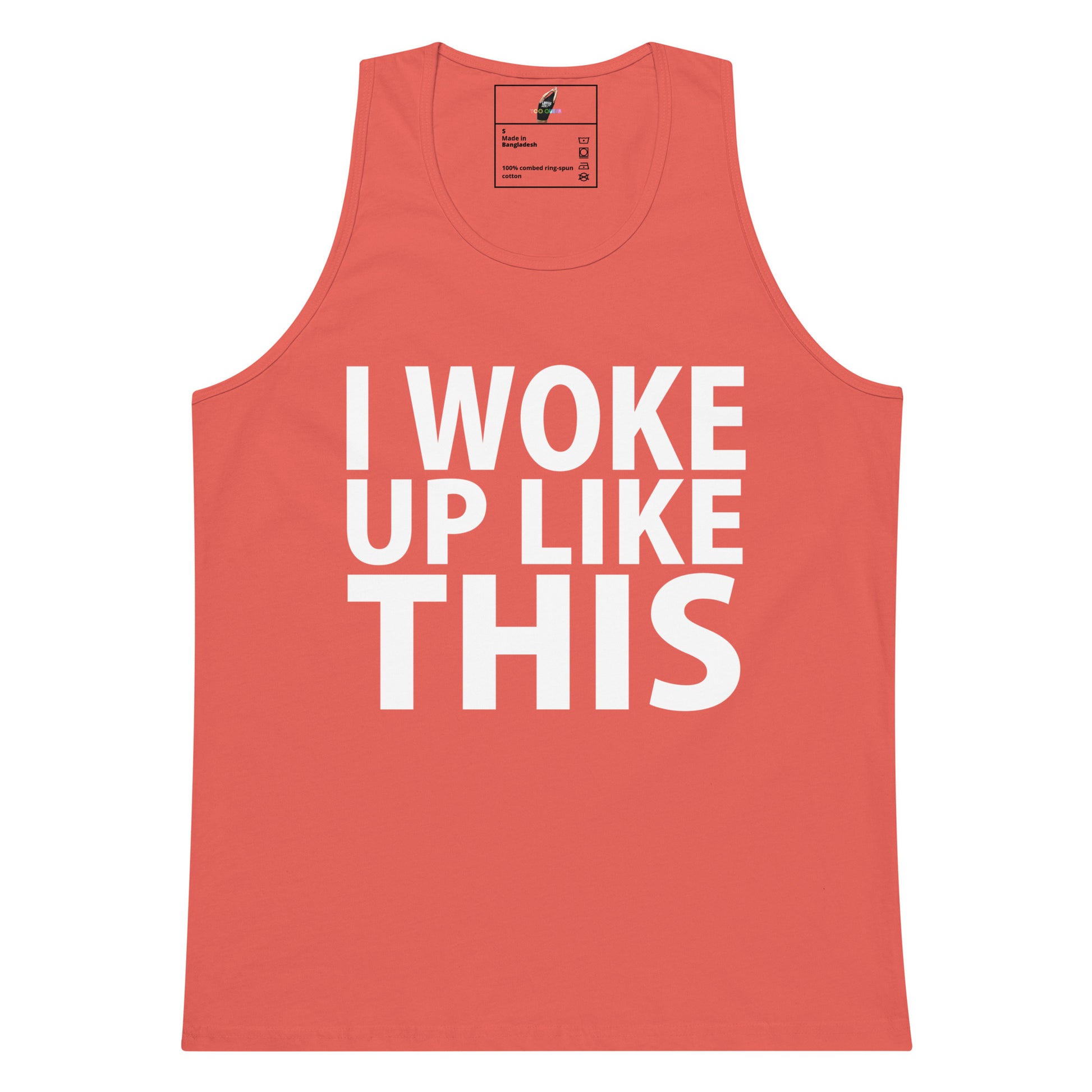 A coral pink sleeveless tank top with the phrase 'I WOKE UP LIKE THIS' printed in bold white capital letters across the front, shown on a plain white background.