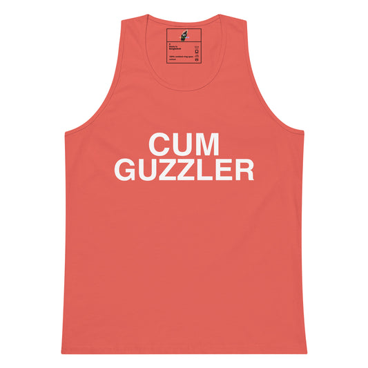 A coral pink sleeveless tank top with the words 'CUM GUZZLER' printed in bold white capital letters across the chest, displayed flat against a solid white background.