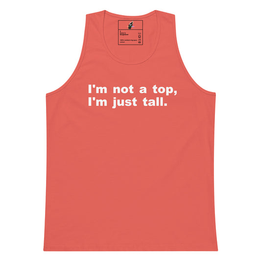 A coral pink tank top with the white printed text 'I'm not a top, I'm just tall.' on the chest, displayed flat against a solid white background.