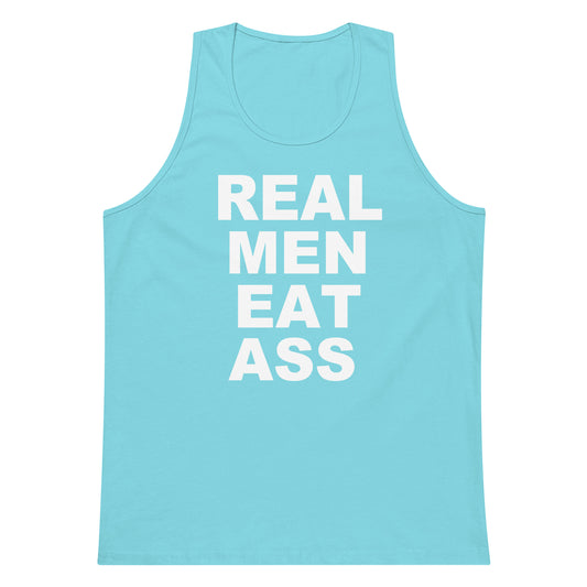 A light blue tank top with bold white text reading 'REAL MEN EAT ASS' printed on the front, shown against a plain white background.