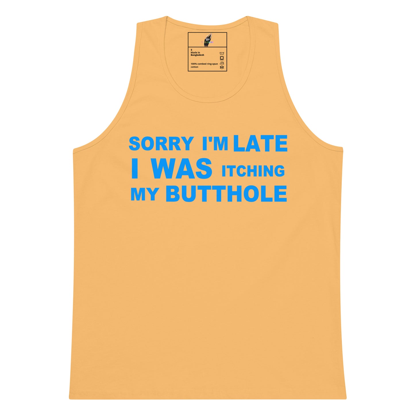 A light peach-colored tank top with bold blue text on the front that reads 'SORRY I'M LATE I WAS ITCHING MY BUTTOLE'. The tank top is displayed flat against a solid white background, with a small brand label visible inside the collar.