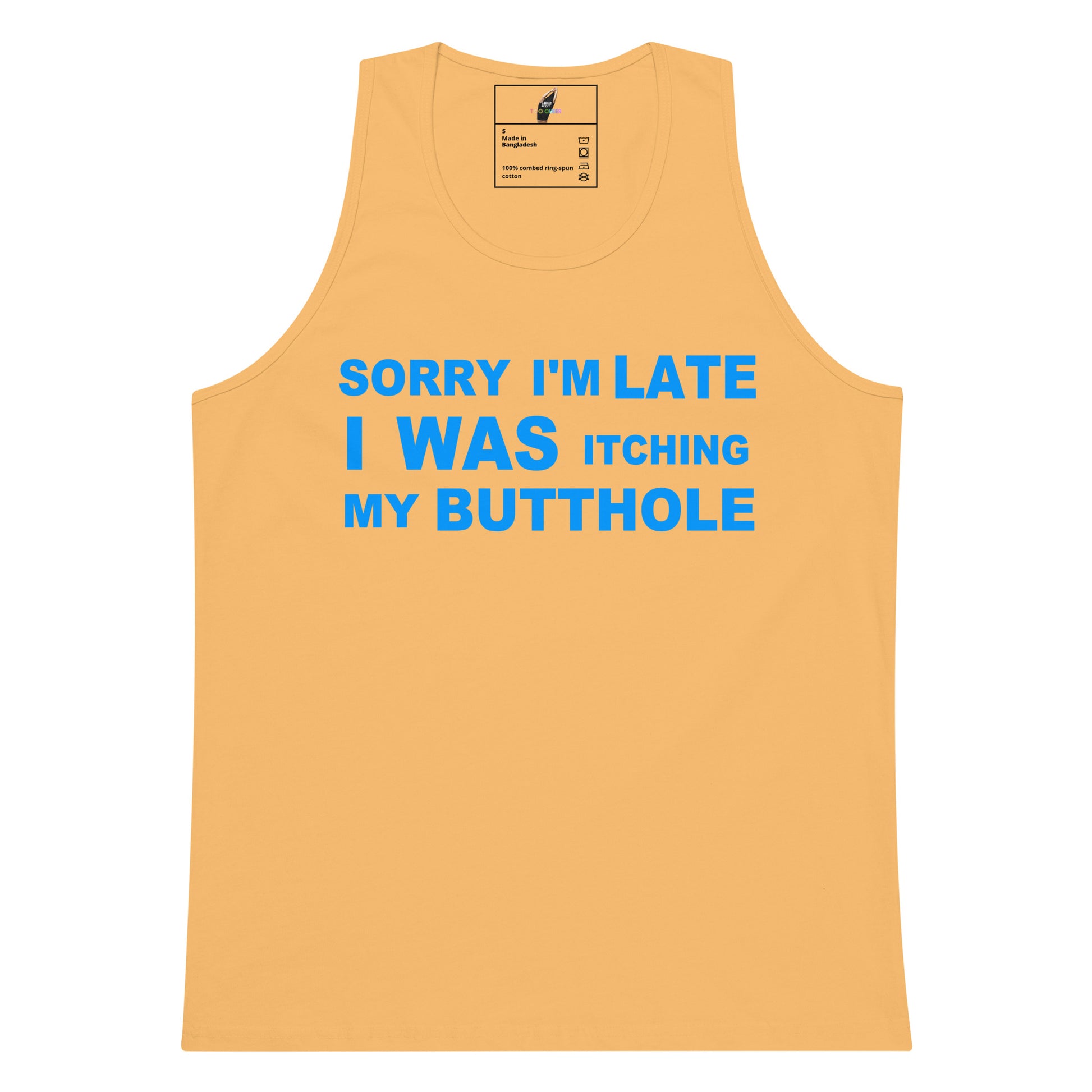 A light peach-colored tank top with bold blue text on the front that reads 'SORRY I'M LATE I WAS ITCHING MY BUTTOLE'. The tank top is displayed flat against a solid white background, with a small brand label visible inside the collar.