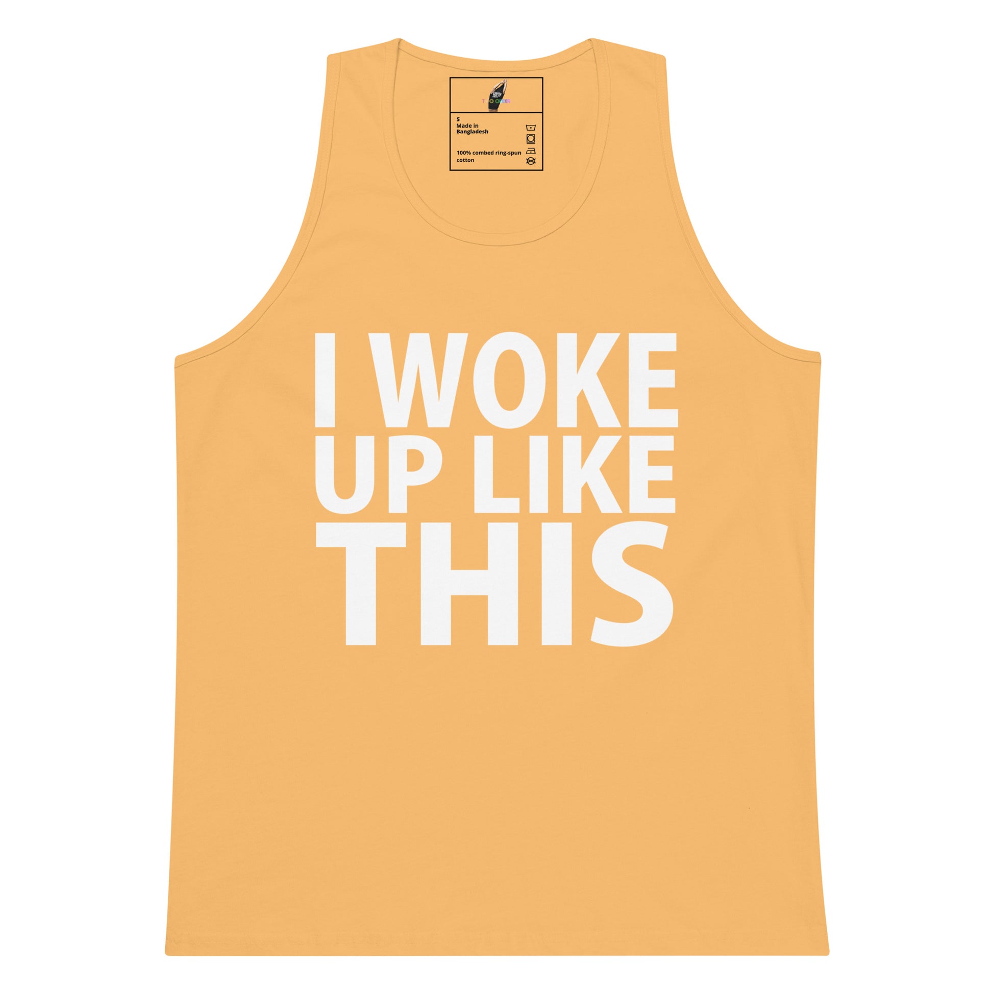 A sleeveless tank top in a warm peach-orange color with the phrase 'I WOKE UP LIKE THIS' printed in large white block letters across the front, shown on a plain white background.