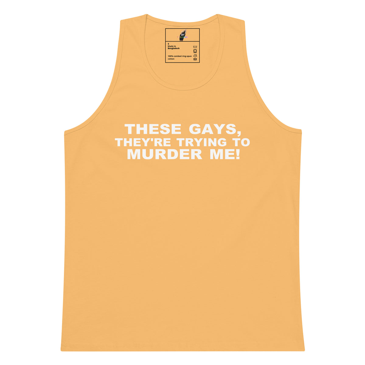 A light peach-colored tank top with bold white text on the chest that reads 'THESE GAYS, THEY'RE TRYING TO MURDER ME!'. The tank top is displayed flat against a solid white background.