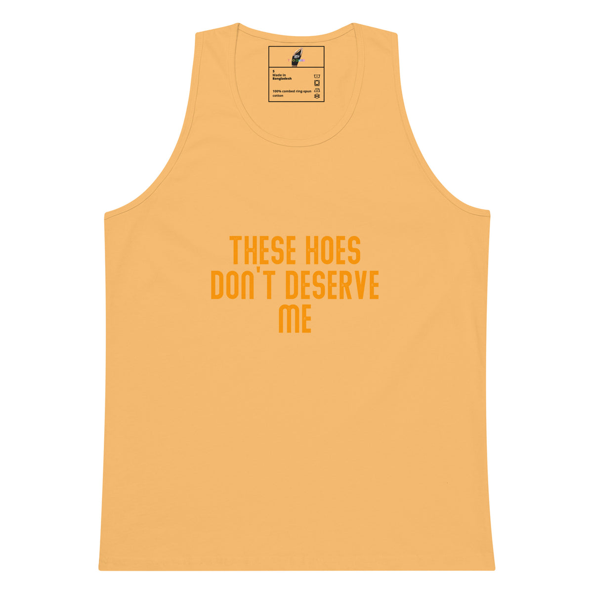 A light peach-colored tank top with the text 'THESE HOES DON'T DESERVE ME' printed in orange on the front, displayed against a solid white background.