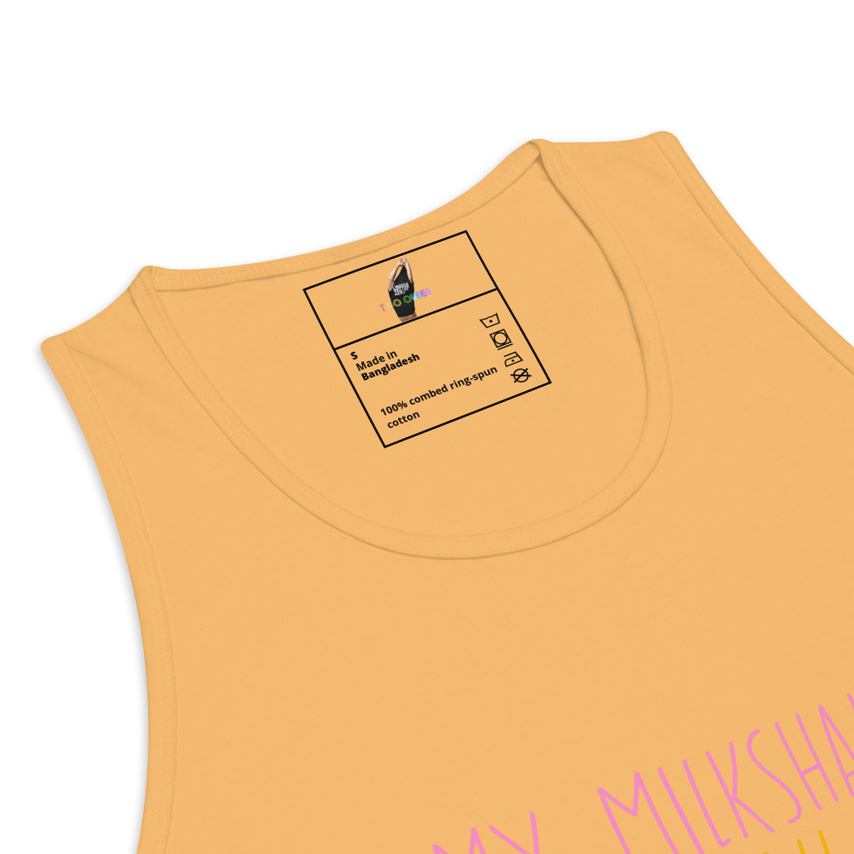 Close-up of a sleeveless tank top in a warm mustard yellow color, showing the inner neck label and part of a pink graphic print at the bottom right.
