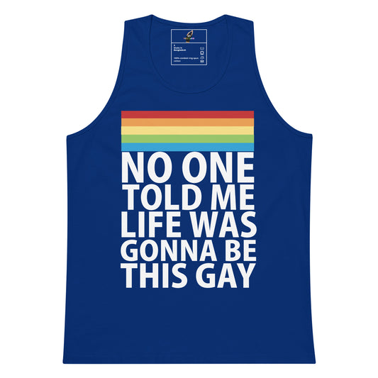 A royal blue tank top with a rainbow stripe graphic and the text 'NO ONE TOLD ME LIFE WAS GONNA BE THIS GAY' printed in white on the front, shown on a plain white background.