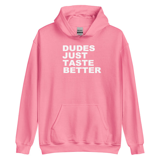 A pink pullover hoodie with the phrase 'DUDES JUST TASTE BETTER' printed in bold white capital letters across the chest, displayed on a clean white background.