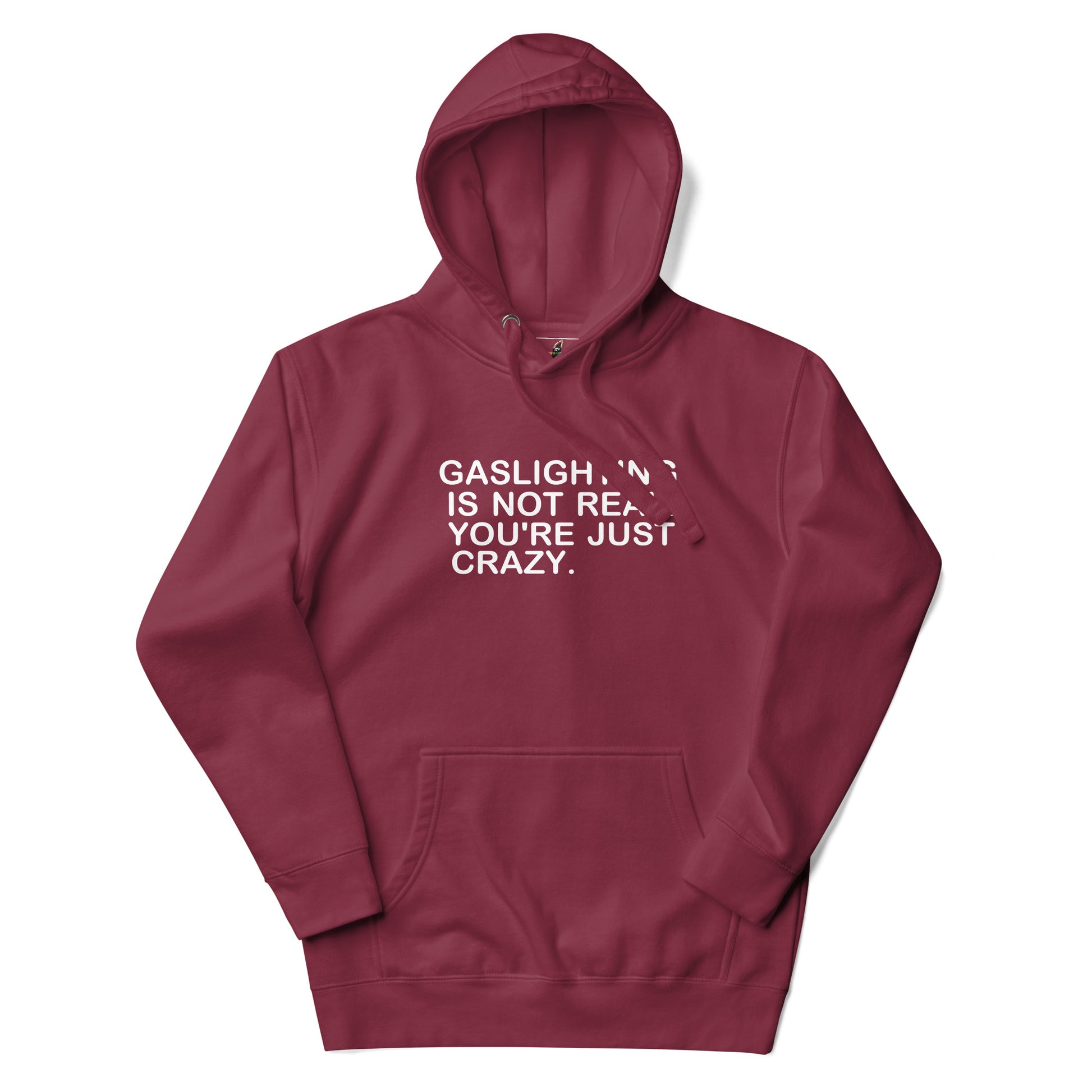 A maroon pullover hoodie with white text on the chest reading 'GASLIGHT "N" IS NOT REAL. YOU'RE JUST CRAZY.