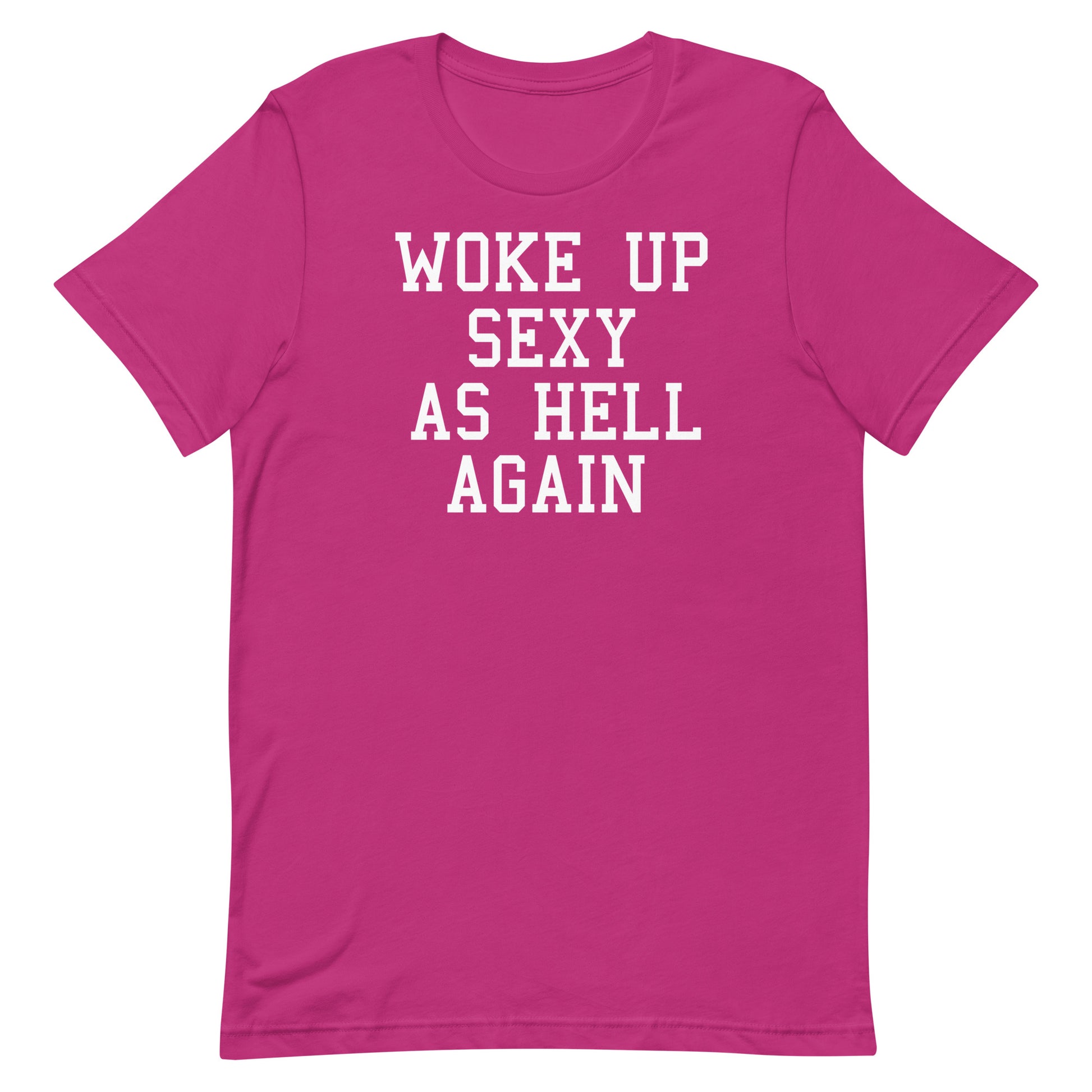 A bright pink short-sleeve t-shirt with bold white text on the front reading 'WOKE UP SEXY AS HELL AGAIN'.