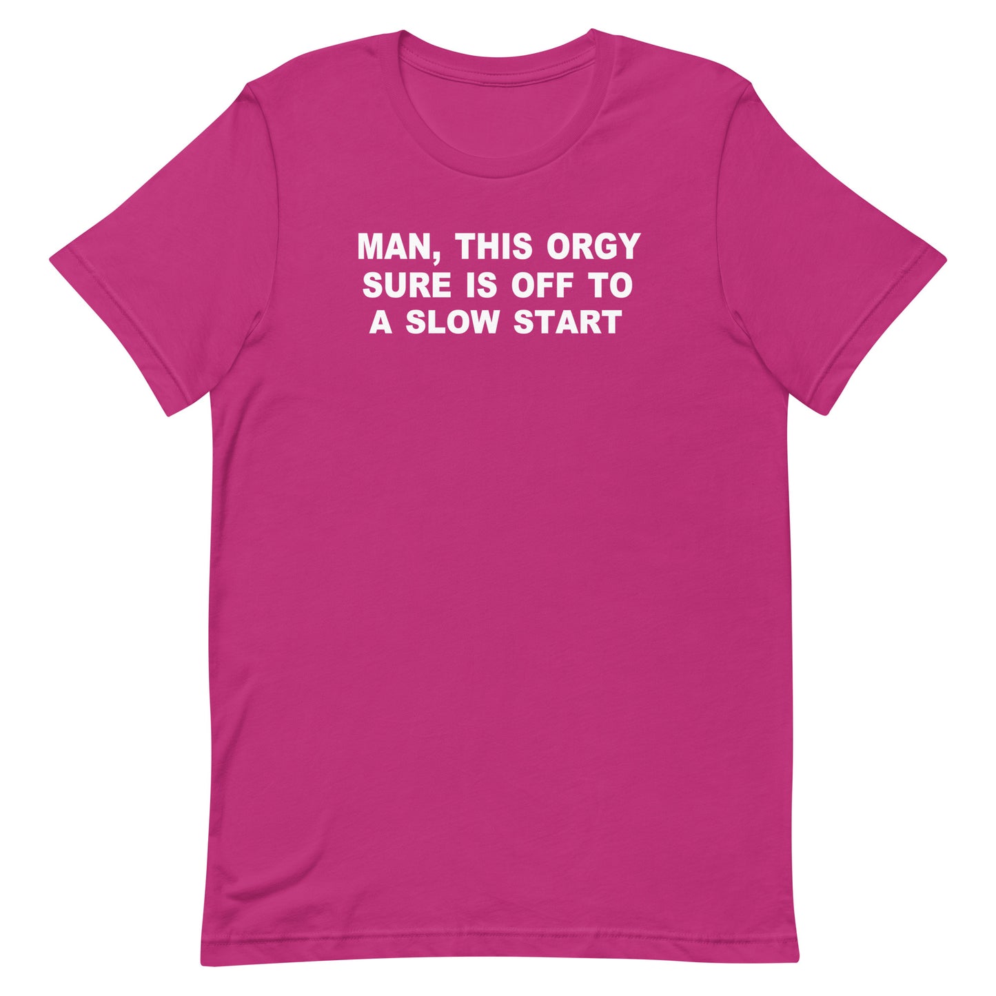 A bright pink short-sleeve crewneck t-shirt with bold white text on the chest that reads 'MAN, THIS ORGY SURE IS OFF TO A SLOW START'. The t-shirt is presented flat against a solid white background.