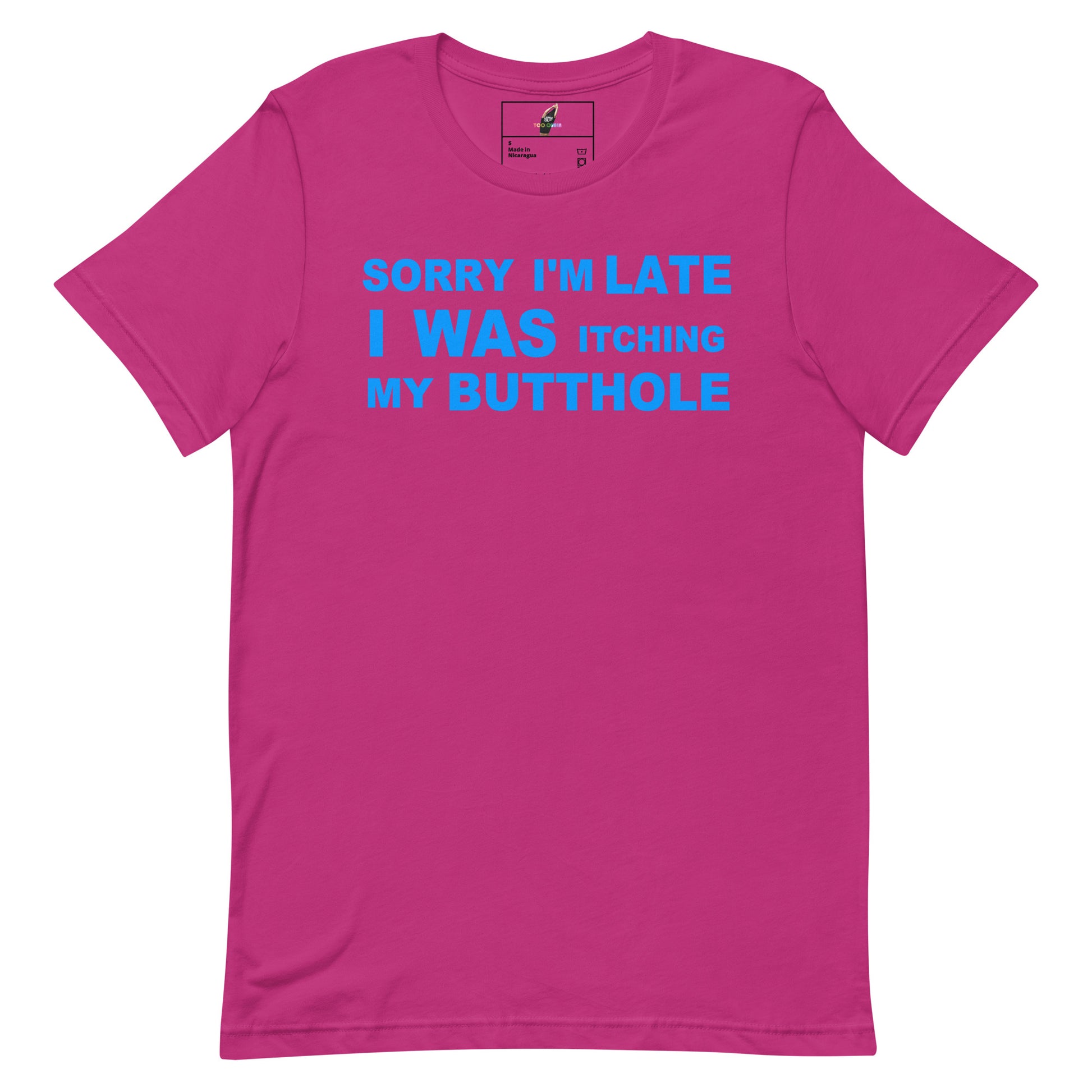 A bright pink short-sleeve t-shirt with a bold blue graphic text on the chest that reads 'SORRY I'M LATE I WAS ITCHING MY BUTTOHOLE'. The t-shirt is displayed flat against a solid white background.