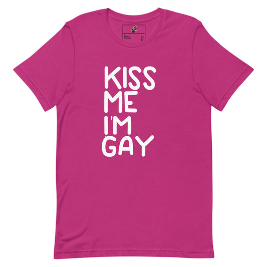 A bright pink short-sleeve crewneck t-shirt with the phrase 'KISS ME I'M GAY' printed vertically in bold white letters on the front, displayed on a clean white background.