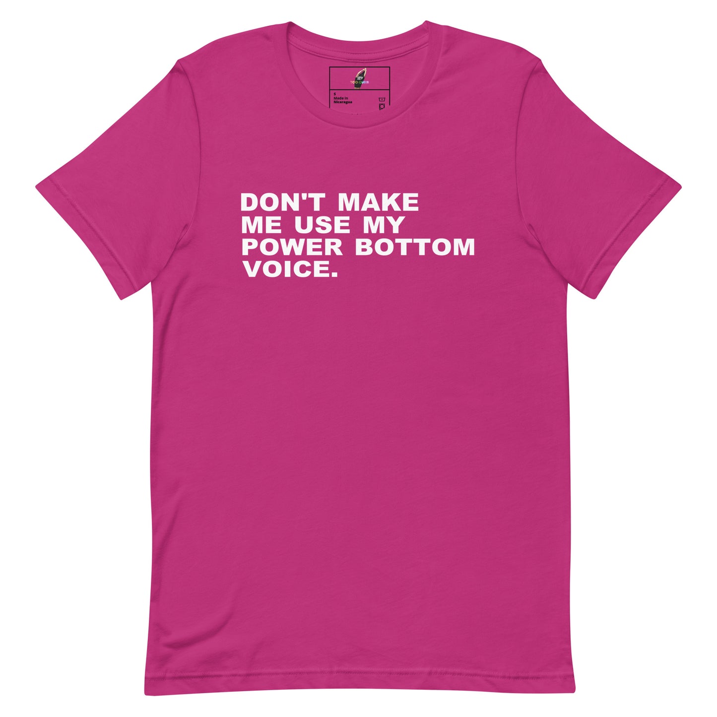 A bright pink short-sleeve t-shirt with the phrase 'DON'T MAKE ME USE MY POWER BOTTOM VOICE.' printed in bold white capital letters across the chest, displayed flat against a plain white background.