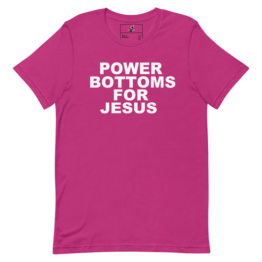 A bright pink short-sleeve t-shirt with bold white text on the front reading 'POWER BOTTOMS FOR JESUS'. The shirt is displayed flat against a clean white background.