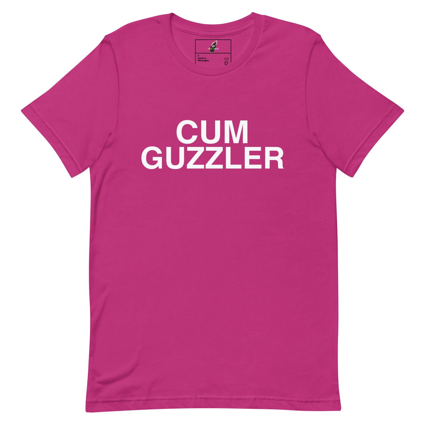 A bright pink short-sleeve crewneck t-shirt with the words 'CUM GUZZLER' printed in bold white capital letters across the chest, displayed on a solid white background.