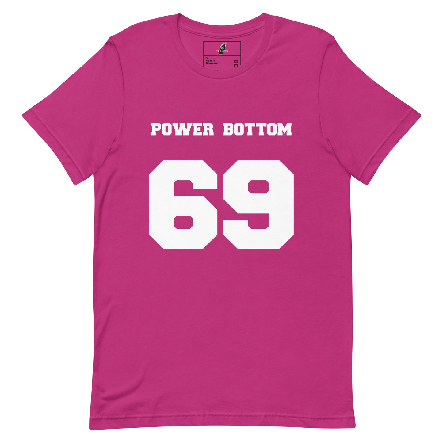 A bright pink short-sleeve t-shirt with 'POWER BOTTOM' and the number '69' printed in bold white block letters on the front, displayed flat against a solid white background.