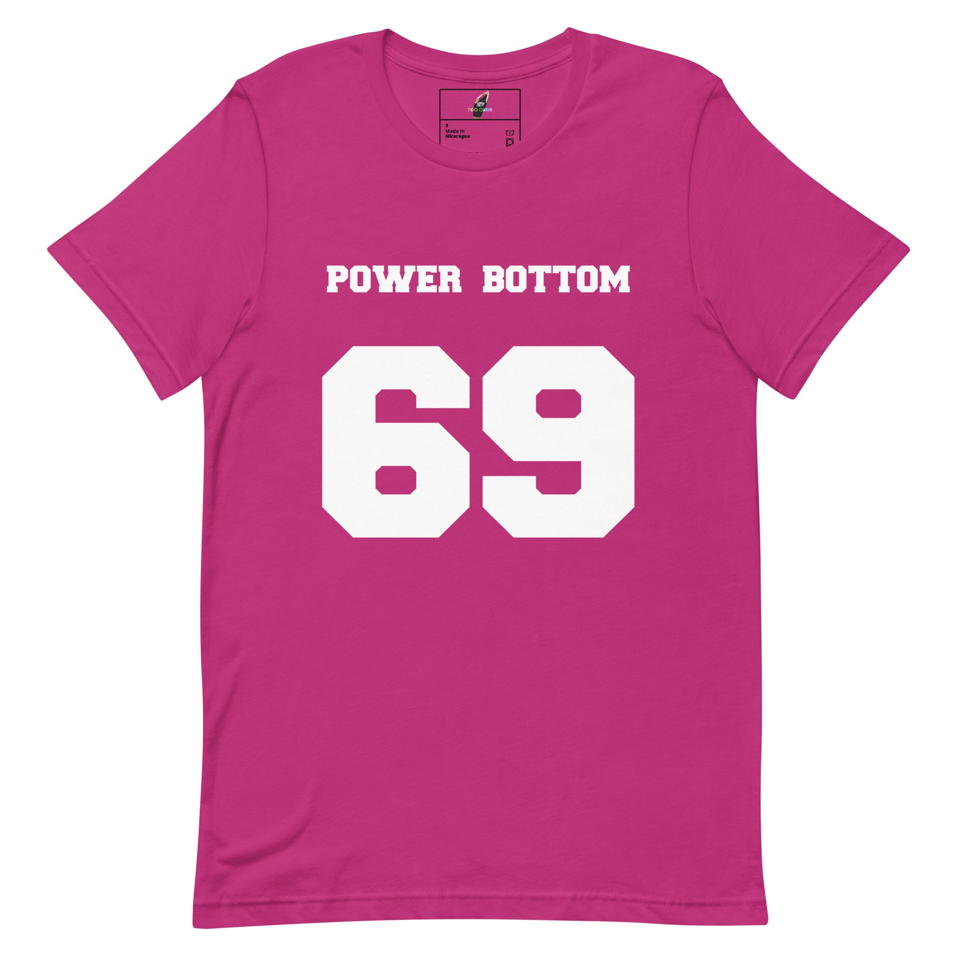 A bright pink short-sleeve t-shirt with 'POWER BOTTOM' and the number '69' printed in bold white block letters on the front, displayed flat against a solid white background.