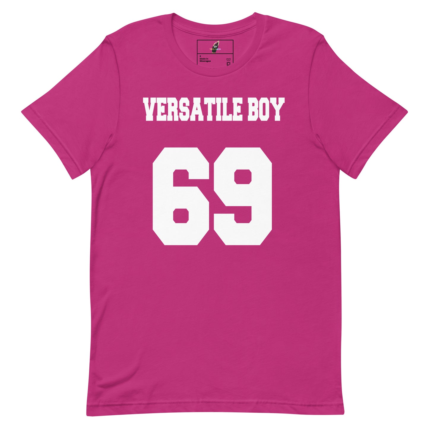 A bright pink short-sleeve t-shirt with 'VERSATILE BOY' and the number '69' printed in bold white block letters on the front, displayed against a solid white background.