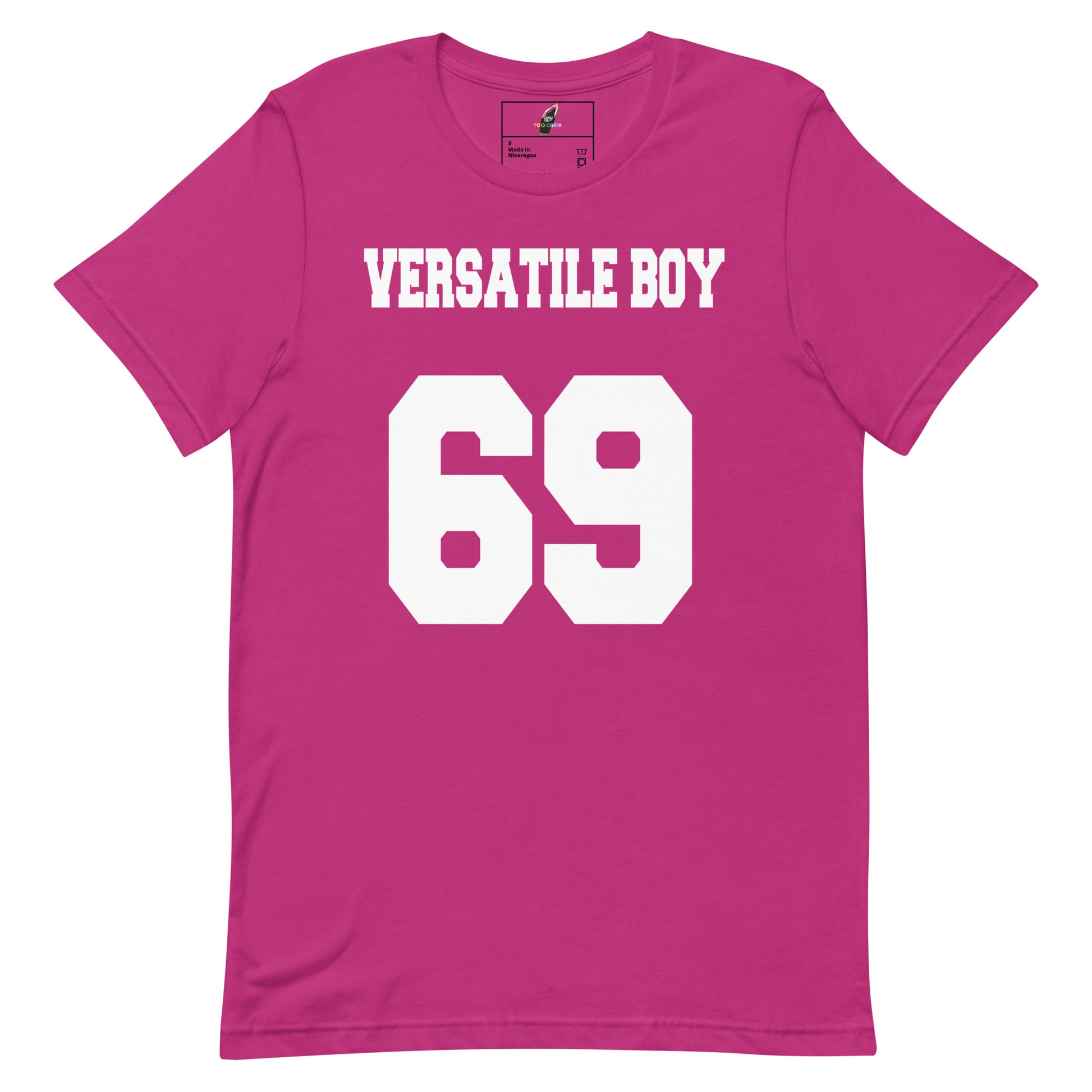 A bright pink short-sleeve t-shirt with 'VERSATILE BOY' and the number '69' printed in bold white block letters on the front, displayed against a solid white background.