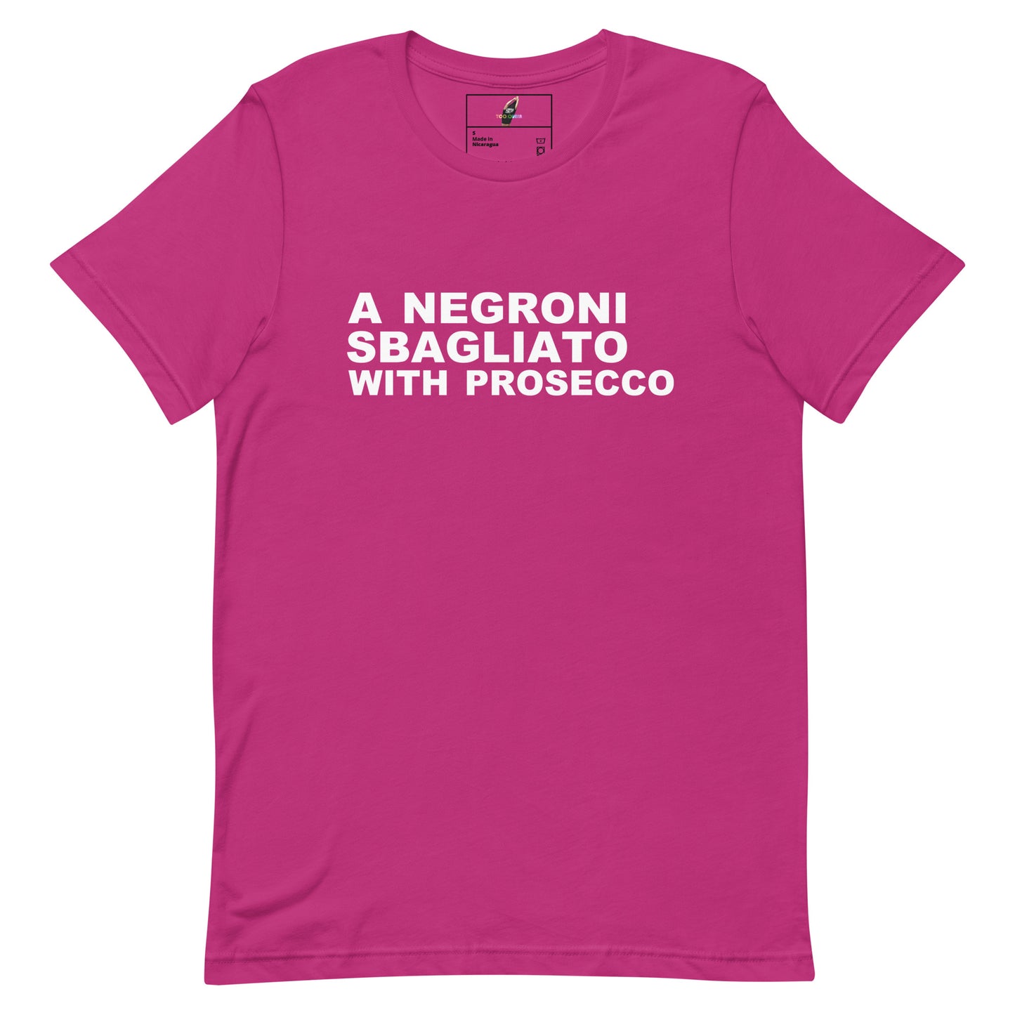 A bright pink short-sleeve crewneck t-shirt with bold white text on the chest reading 'A NEGRONI SBAGLIATO WITH PROSECCO'.
