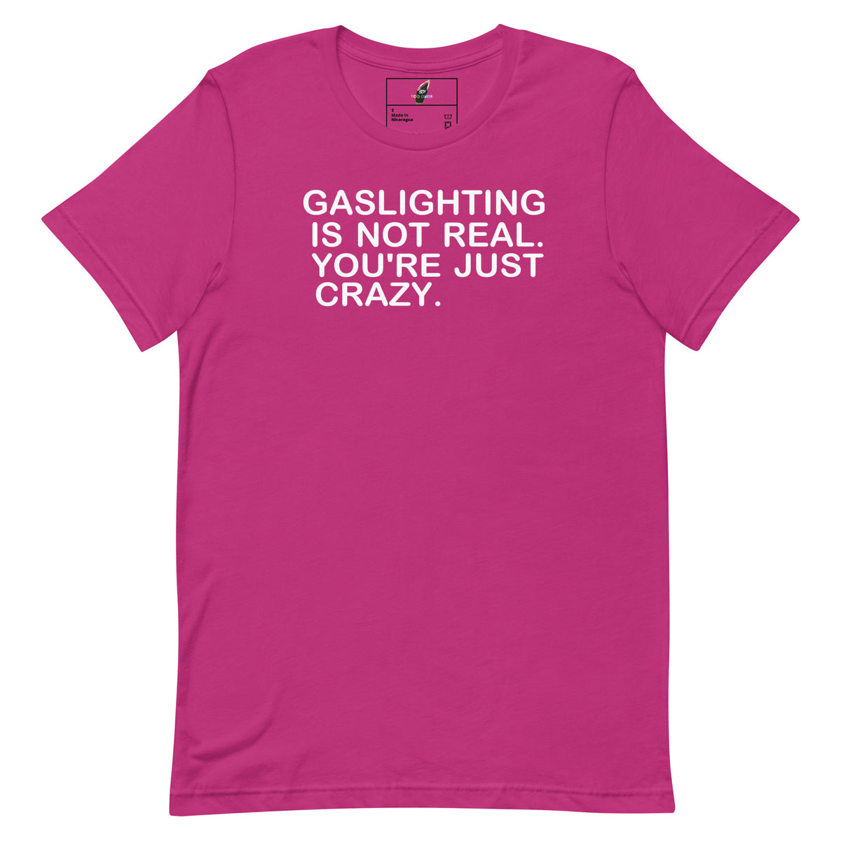 A bright pink short-sleeve t-shirt with the phrase 'GASLIGHTING IS NOT REAL. YOU'RE JUST CRAZY.
