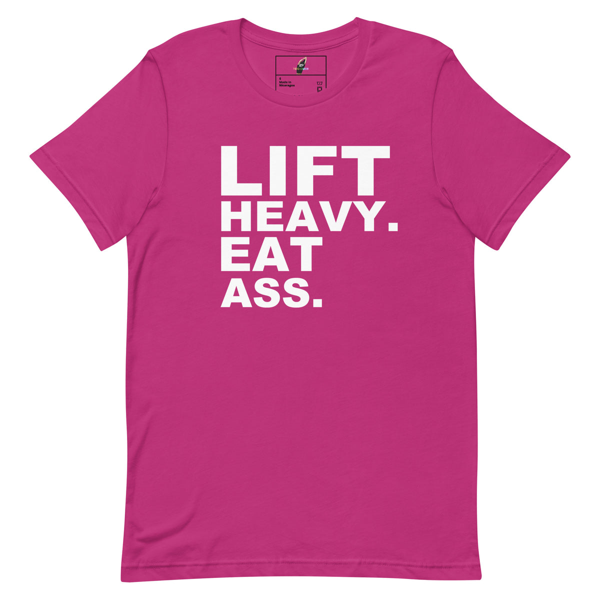 A bright pink short-sleeve t-shirt with bold white text on the front reading 'LIFT HEAVY. EAT ASS.