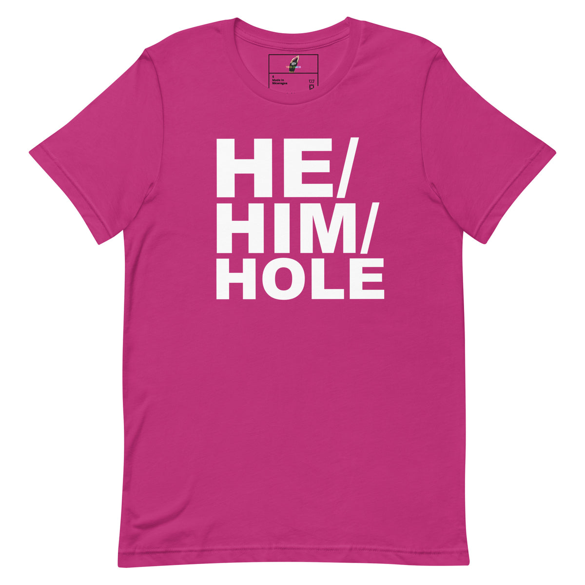 A bright pink short-sleeve t-shirt with the phrase 'HE/HIM/HOLE' printed in large, bold white block letters across the chest, displayed on a clean white background.
