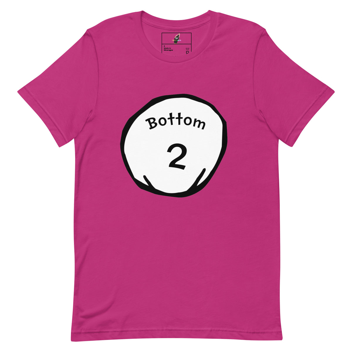 A bright pink short-sleeve t-shirt with a circular graphic on the chest containing the text 'Bottom 2' in black on a white circle with a black outline.