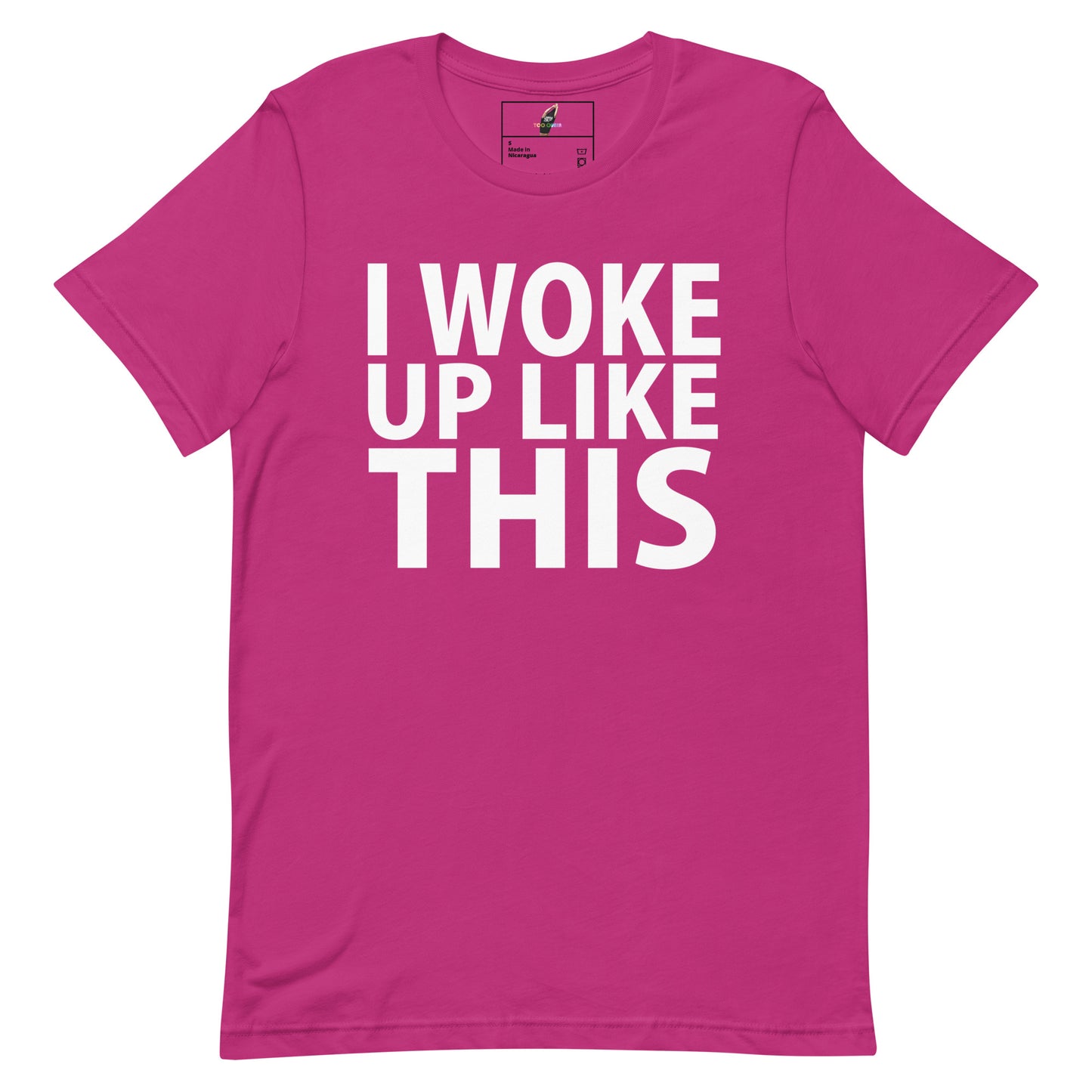 A bright pink short-sleeve t-shirt with bold white text on the front reading 'I WOKE UP LIKE THIS'.