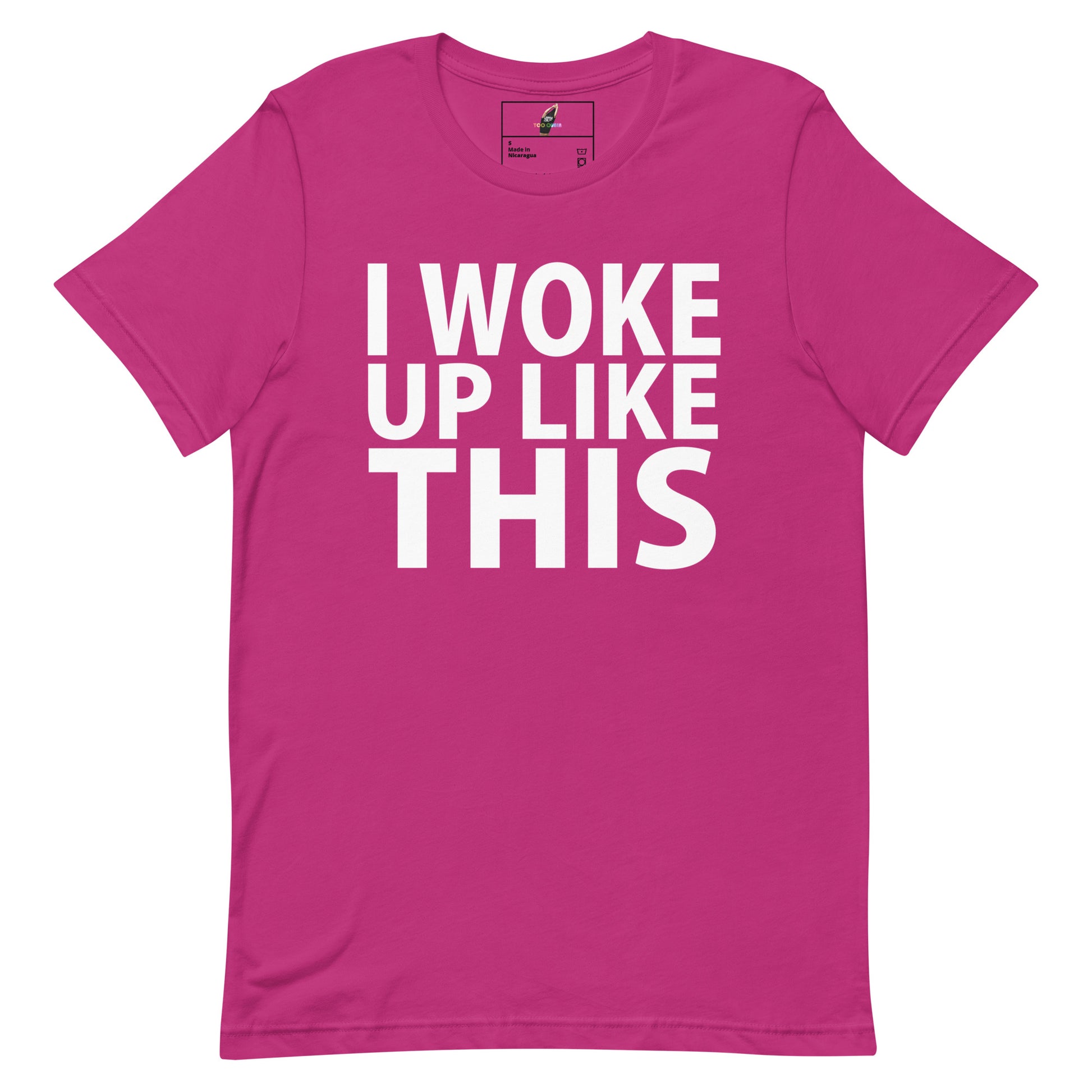 A bright pink short-sleeve t-shirt with bold white text on the front reading 'I WOKE UP LIKE THIS'.
