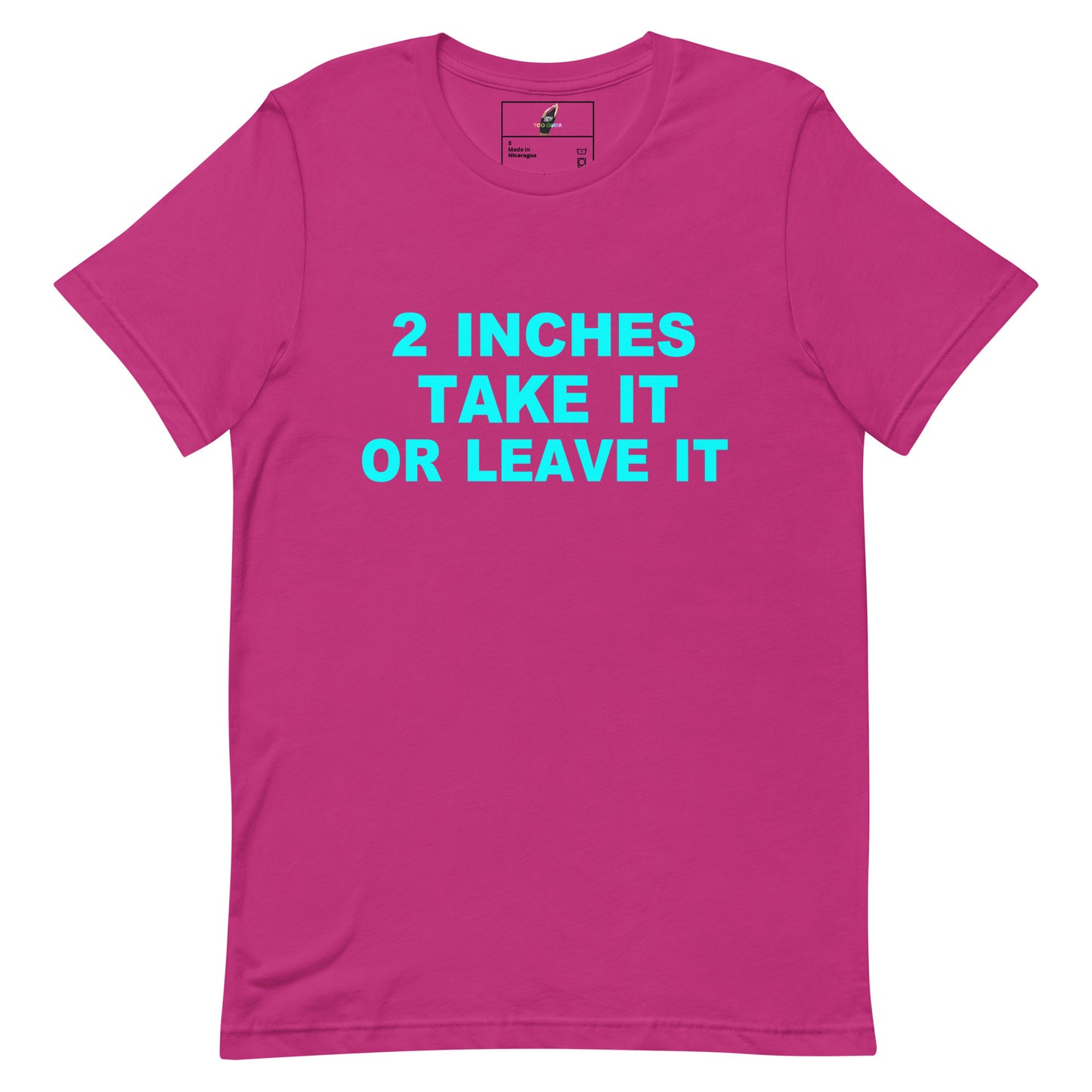 A bright pink short-sleeve t-shirt with the text '2 INCHES TAKE IT OR LEAVE IT' printed in light blue across the chest, displayed on a solid white background.