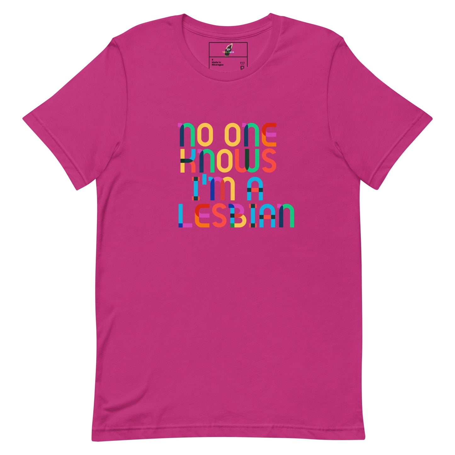 A bright pink short-sleeve t-shirt with a colorful retro-style text graphic on the chest that reads 'no one knows i'm a lesbian' in overlapping multicolored letters.