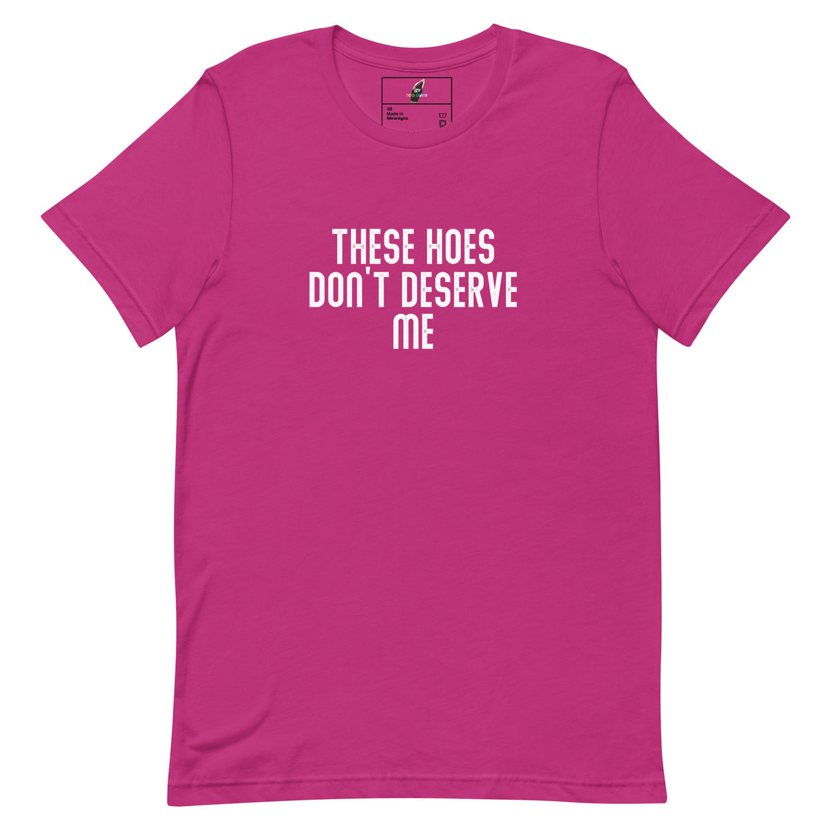 A bright pink short-sleeve t-shirt with the text 'THESE HOES DON'T DESERVE ME' printed in white across the chest, displayed on a solid white background.