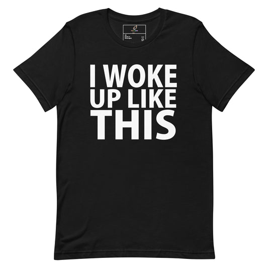 A black short-sleeve crewneck t-shirt with the phrase 'I WOKE UP LIKE THIS' printed in bold white capital letters across the chest, displayed on a solid white background.