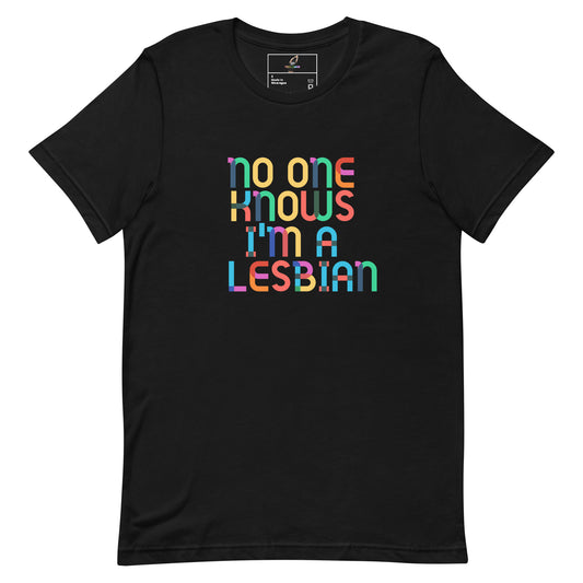 A black short-sleeve crewneck t-shirt featuring a colorful graphic text print that reads 'no one knows i'm a LESBIAN' in a rainbow gradient pattern, displayed on a clean white background.