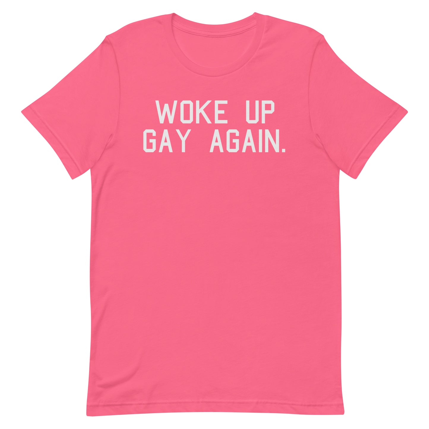 A bright pink short-sleeve t-shirt with the phrase 'WOKE UP GAY AGAIN.' printed in white block letters across the chest, displayed on a clean white background.