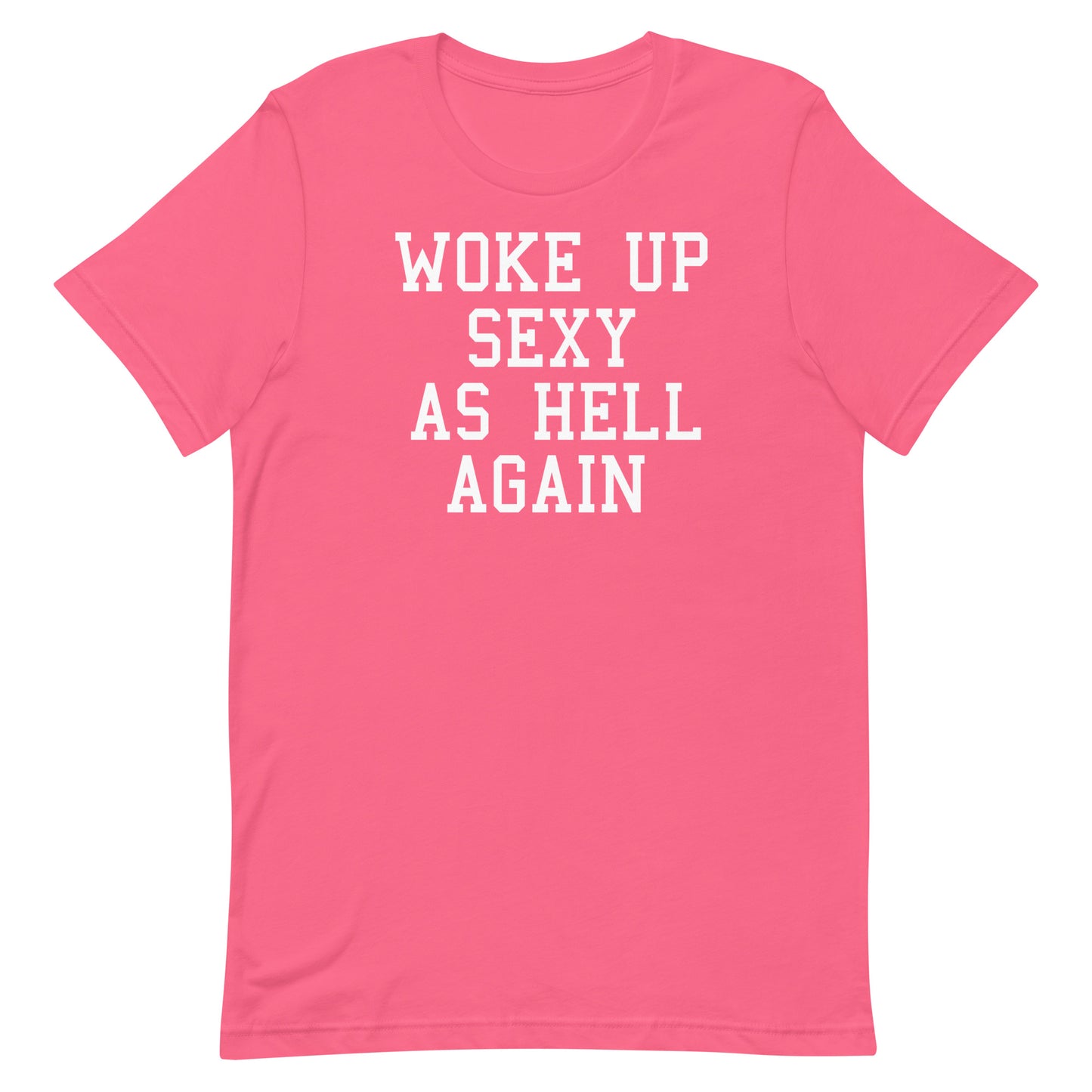 A pink short-sleeve crewneck t-shirt with the phrase 'WOKE UP SEXY AS HELL AGAIN' printed in white block letters across the chest, shown on a plain white background.