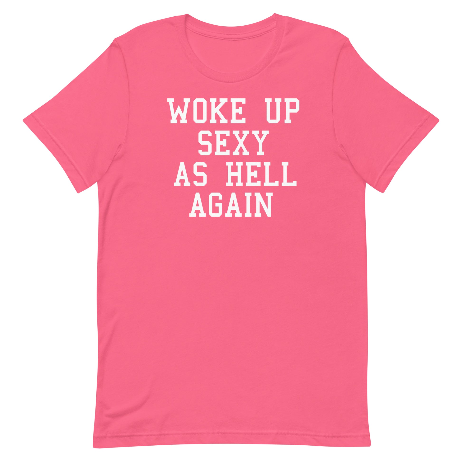 A pink short-sleeve crewneck t-shirt with the phrase 'WOKE UP SEXY AS HELL AGAIN' printed in white block letters across the chest, shown on a plain white background.