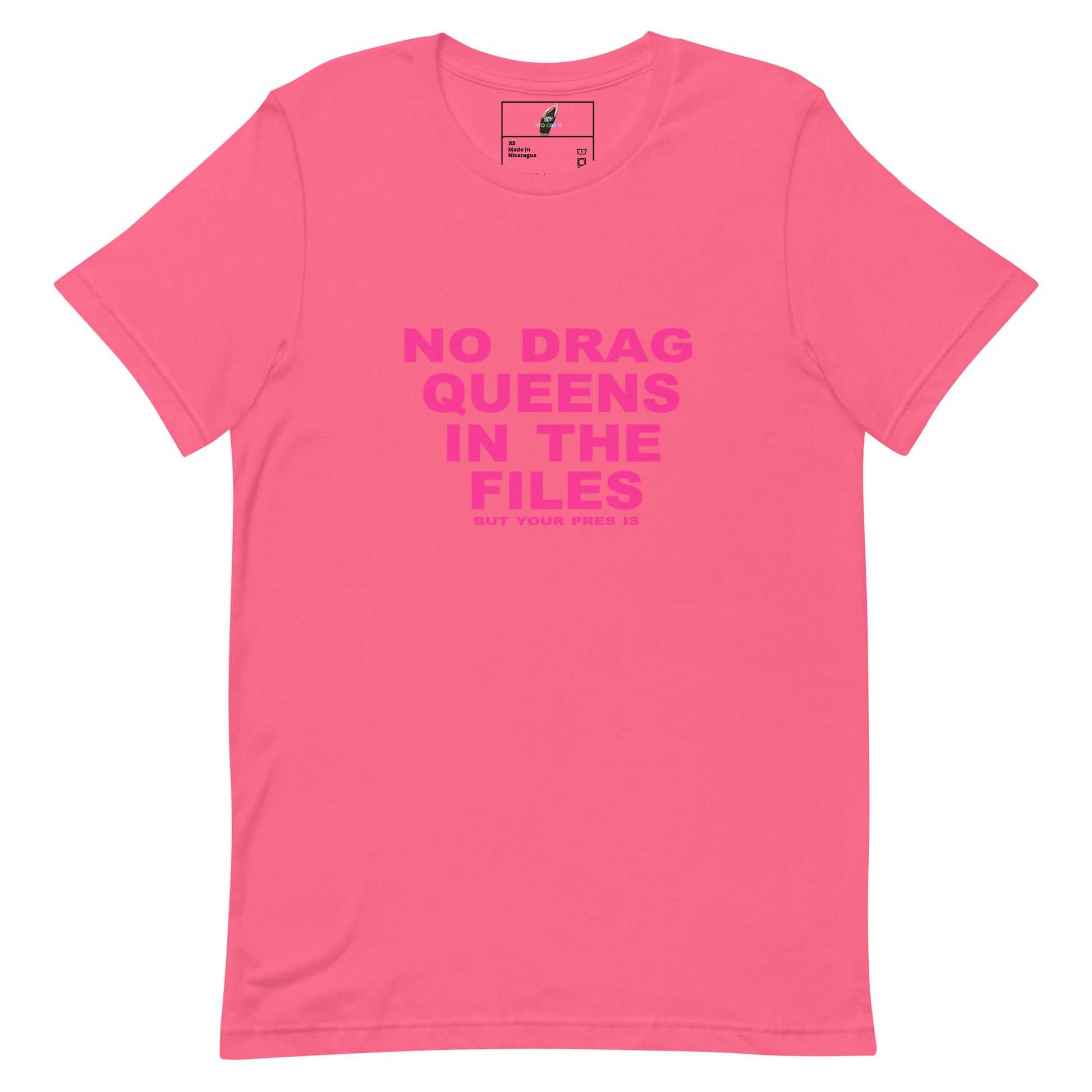 A bright pink short-sleeve t-shirt with bold pink text on the front reading 'NO DRAG QUEENS IN THE FILES' and smaller text below, shown on a plain white background.