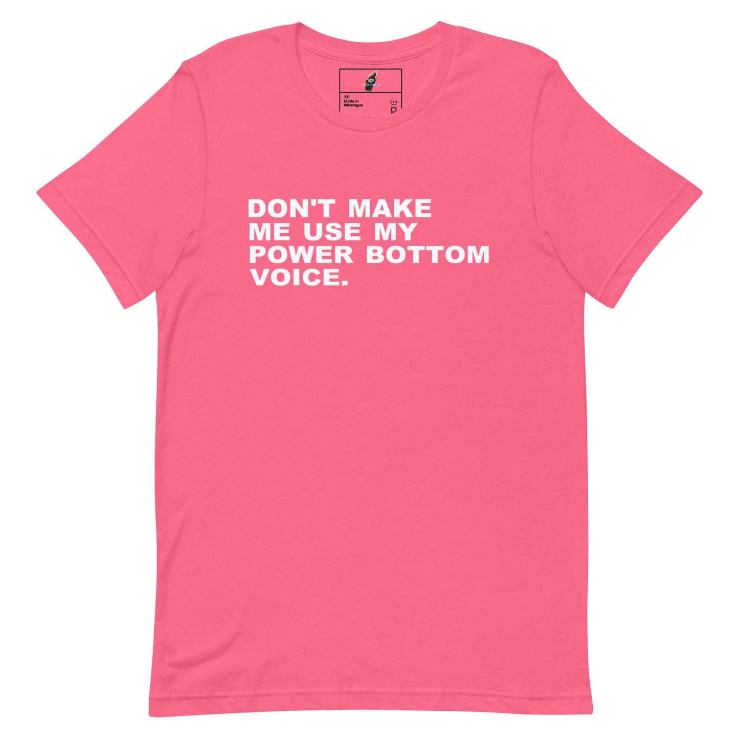 A pink short-sleeve crewneck t-shirt with the slogan 'DON'T MAKE ME USE MY POWER BOTTOM VOICE.' printed in white capital letters across the chest, displayed flat against a white background.