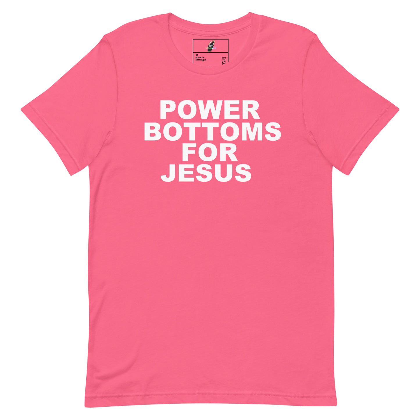 A pink short-sleeve crewneck t-shirt with bold white text on the front reading 'POWER BOTTOMS FOR JESUS'. The shirt is displayed flat against a clean white background, showing a small brand label inside the collar.